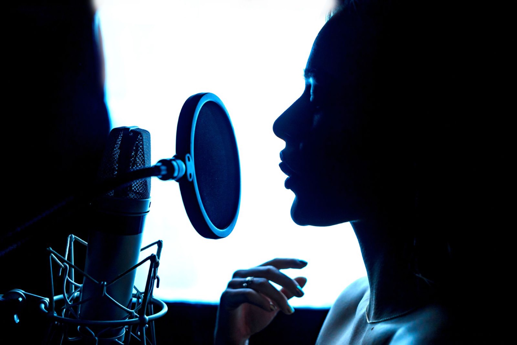 A vocalist recording in the studio