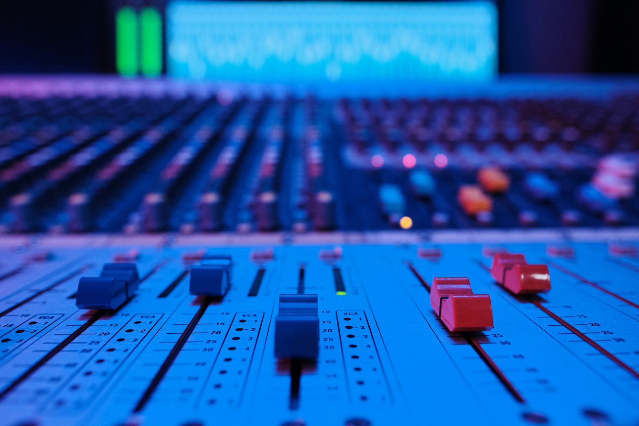 Faders on a studio mixing desk